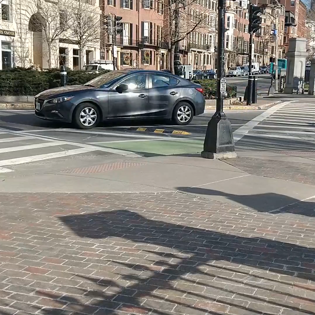 Image of a Car Driving around a Slow Turn Wedge in Boston