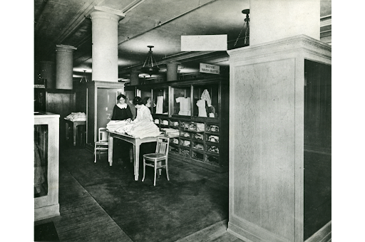 Two unidentified students from the retail class that became the Prince School of Retailing pose in the boys' clothing department of the Filene & Sons Company in Boston, 1912, Courtesy of University Archives Simons.