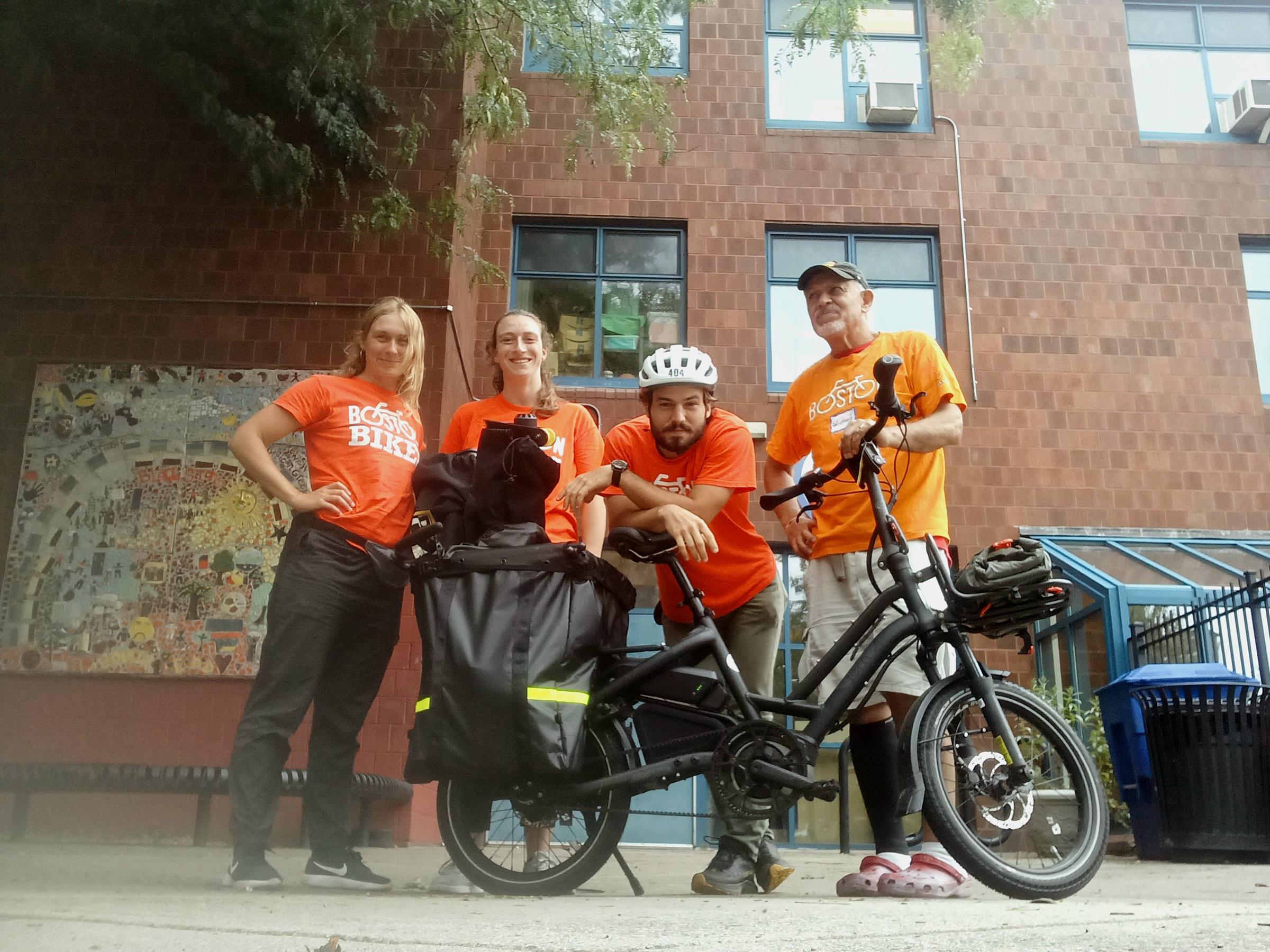 members of the Boston Bikes program posing with one of the employee e-cargo bikes
