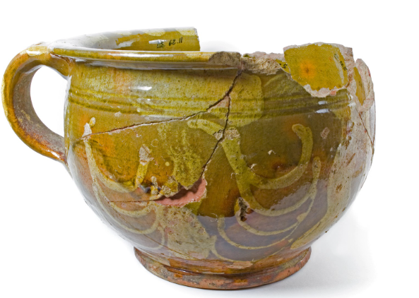 A chamber pot found at the Three Cranes Tavern in Charlestown featuring the distinctive C-shaped stacked swags and vertical bars of the Parker/Jack and Acton pottery.