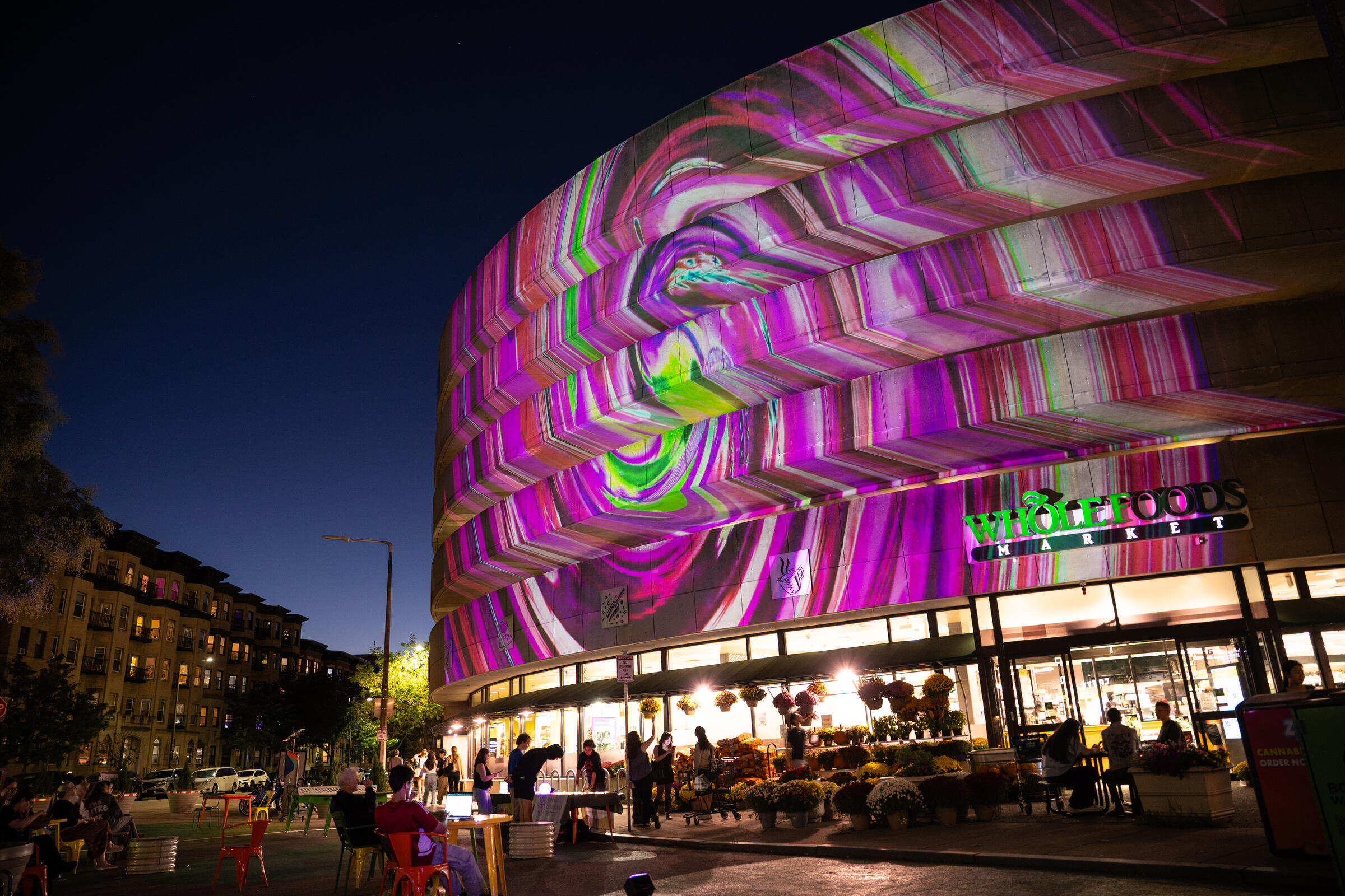 A photo showing a colorful light projection on the side of a building