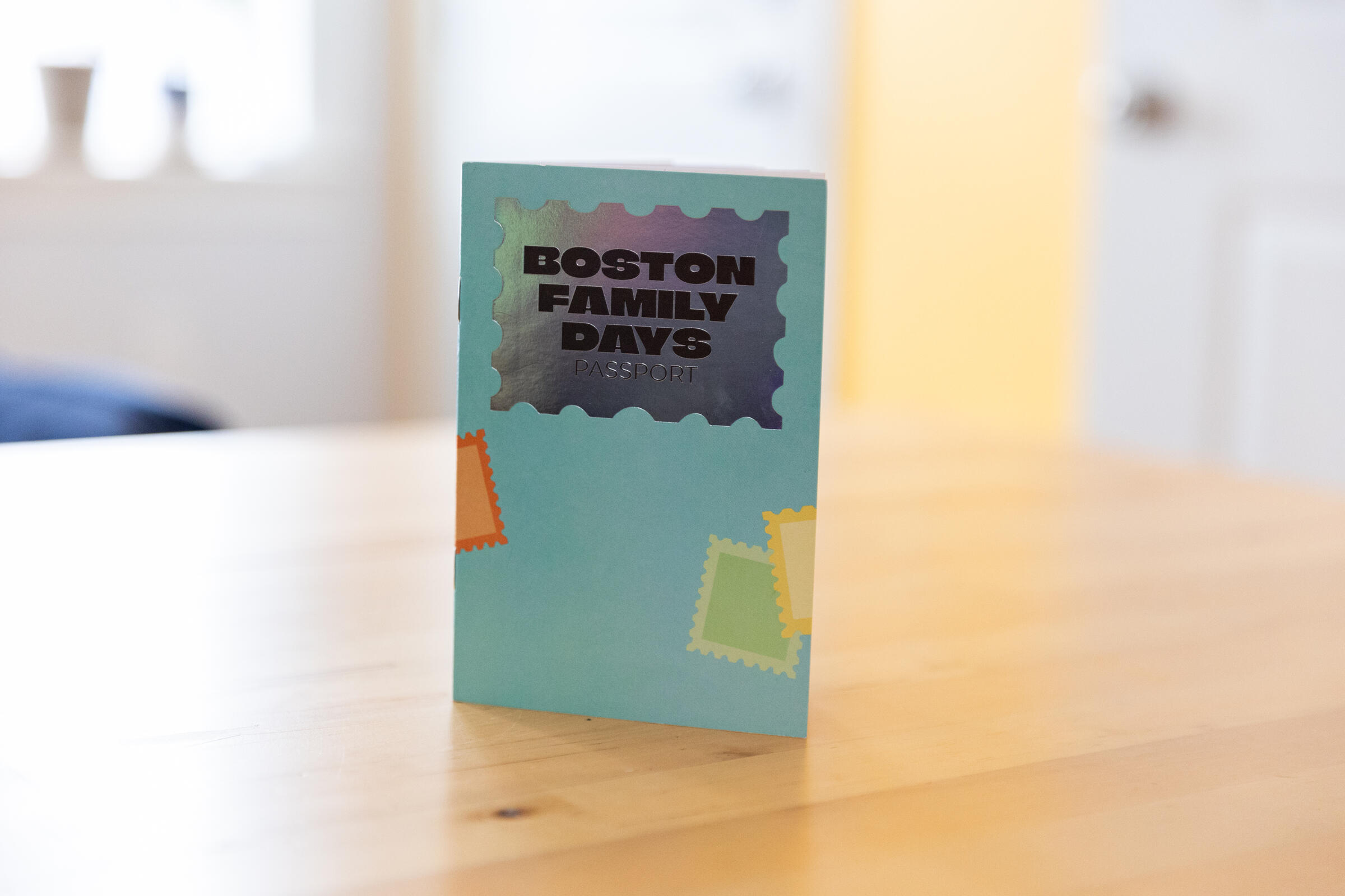Small blue stamp book with metallic title "Boston Family Days Passport"