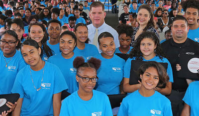 Image shows a group of teens from the "Superteens" program. Each teen is wearing a blue shirt. 