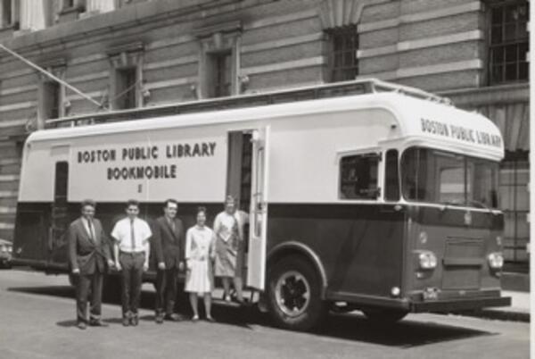 a black and white photo of people standing in front of a van that says "Boston Public Library Bookmobile" on the side