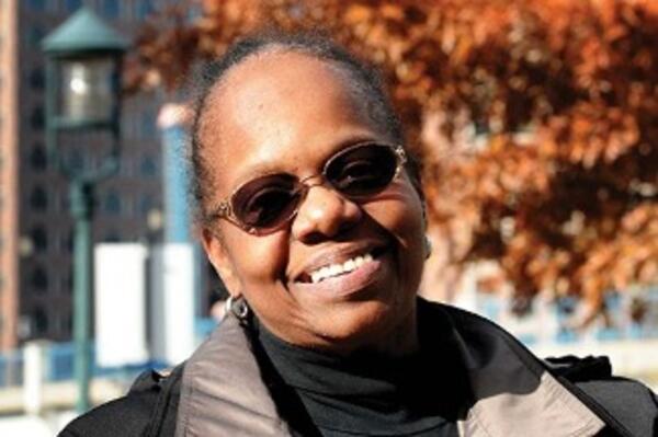 an image of a woman wearing glasses and smiliing