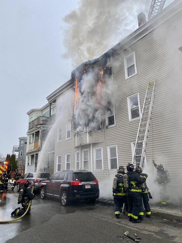 an image of firefighters putting out a fire in a triple decker