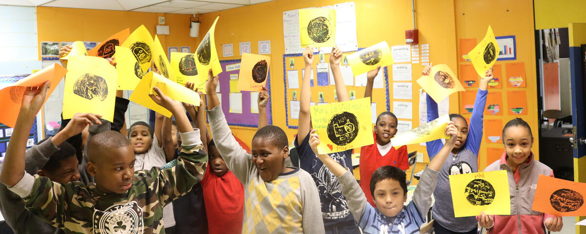 Image for students at josiah quincy elementary school hold up their newly made prints