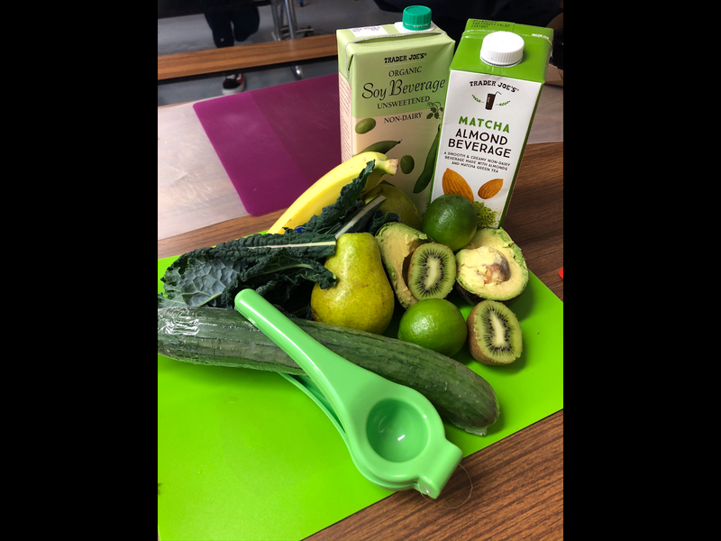 Students make a Green Smoothie with kale, kiwi, avocado, pear, and limes