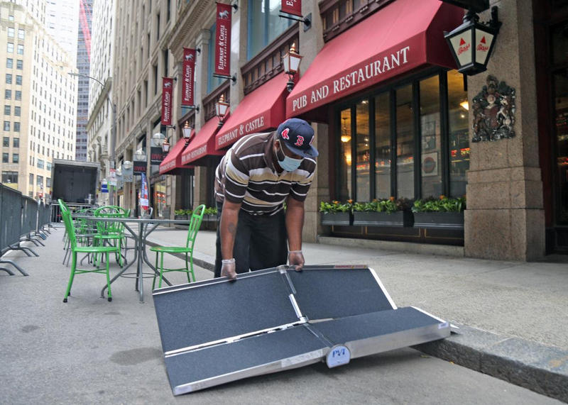 Irwin Edwards sets up their new accessibility ramp at Elephant & Castle in downtown Boston. (Mayor's Office Photo by John Wilcox)