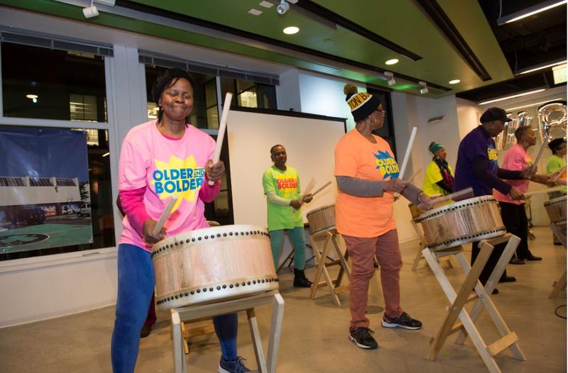 Photo of older adults taiko drumming