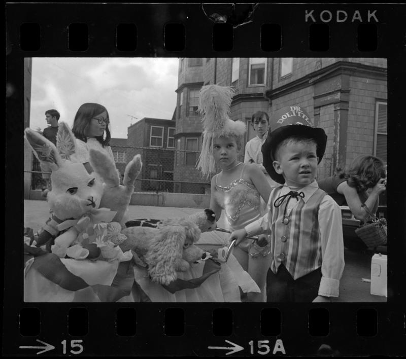 Children dressed in Dr. Dolittle costumes and standing with their carriage in Bunker Hill Day Parade 