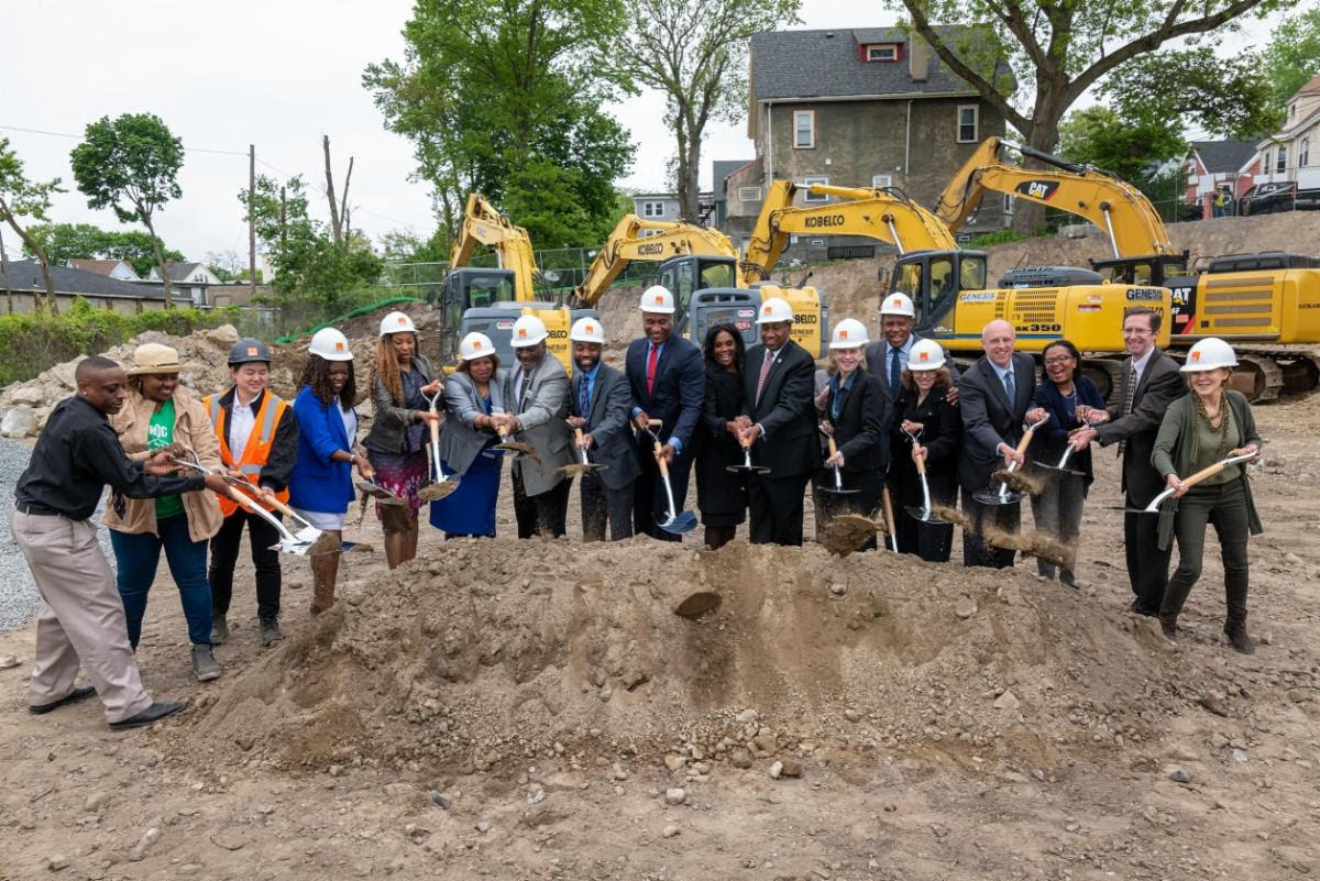 Development team members and City officials hold shovels to celebrate the Morton Station Village groundbreaking.