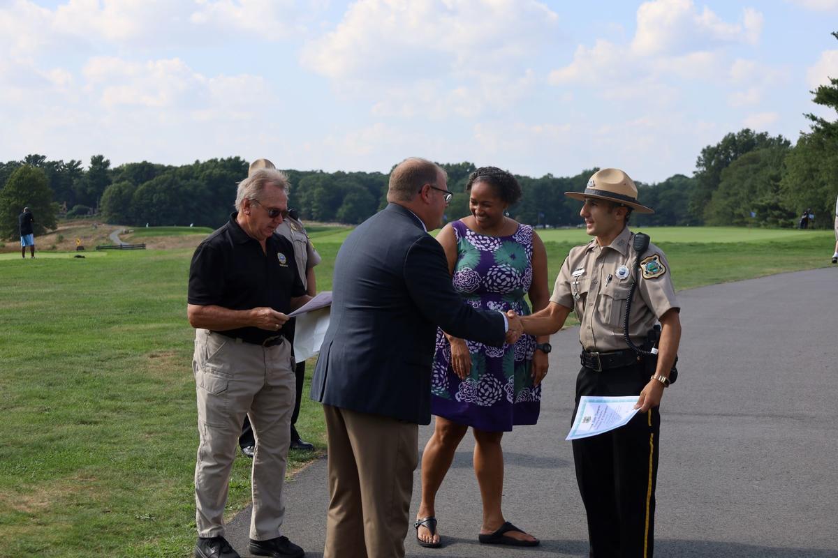Ranger shaking hands with Parks Staff