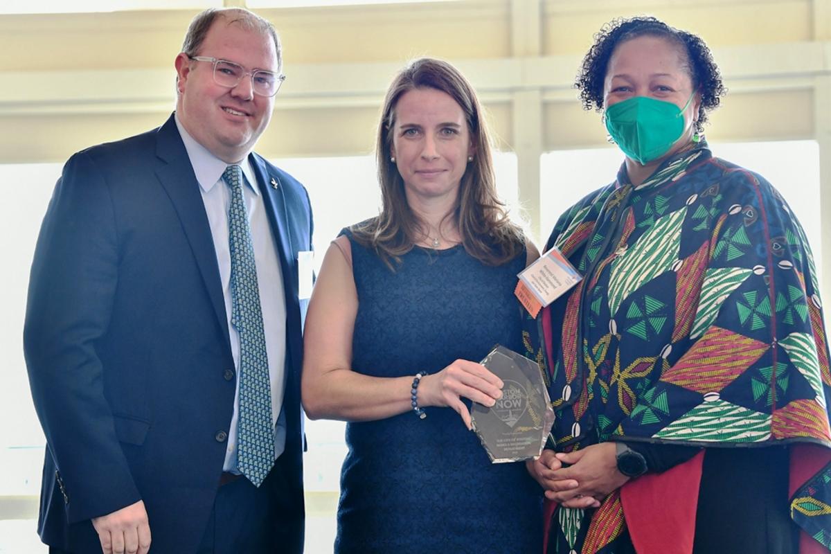 Event co-chair Diana Pisciotta (center) presents the Onboard Award to Boston Parks Commissioner Ryan Woods and Reverend Mariama White-Hammond.