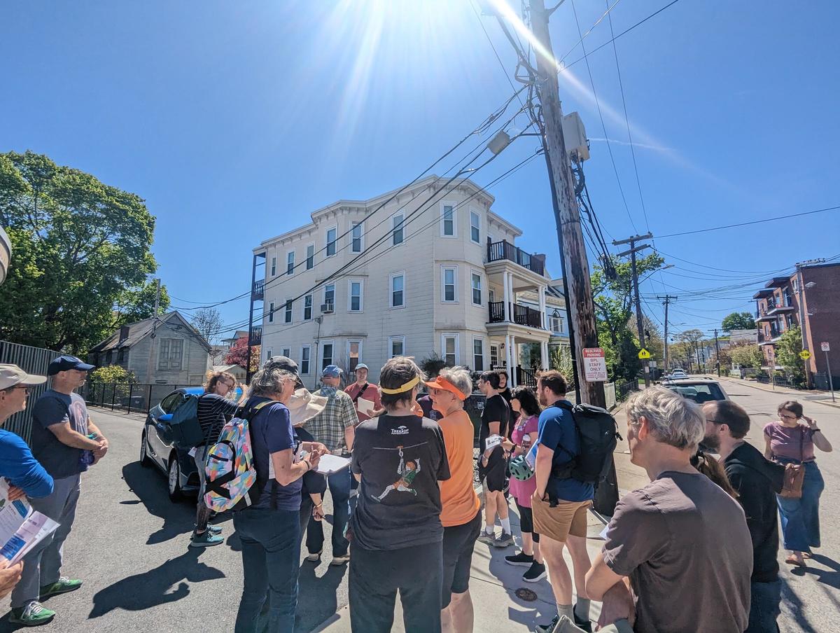 Photo of community members gathering on a sidewalk for the Poplar Street community walk