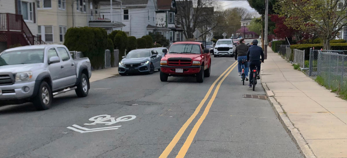 A photograph of a contraflow bike lane on Mount Hope Street in Roslindale.