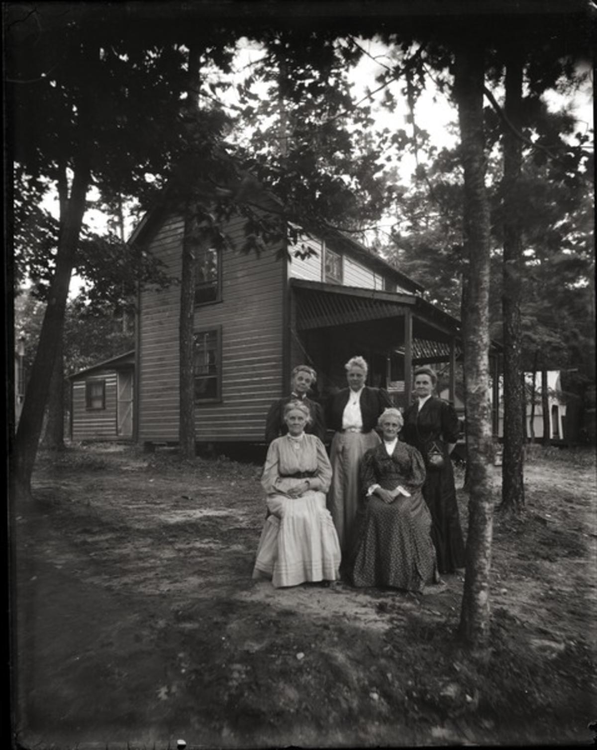 Cottage and residents, Lake Pleasant: Five women posed in front of their cottage, ca. 1900