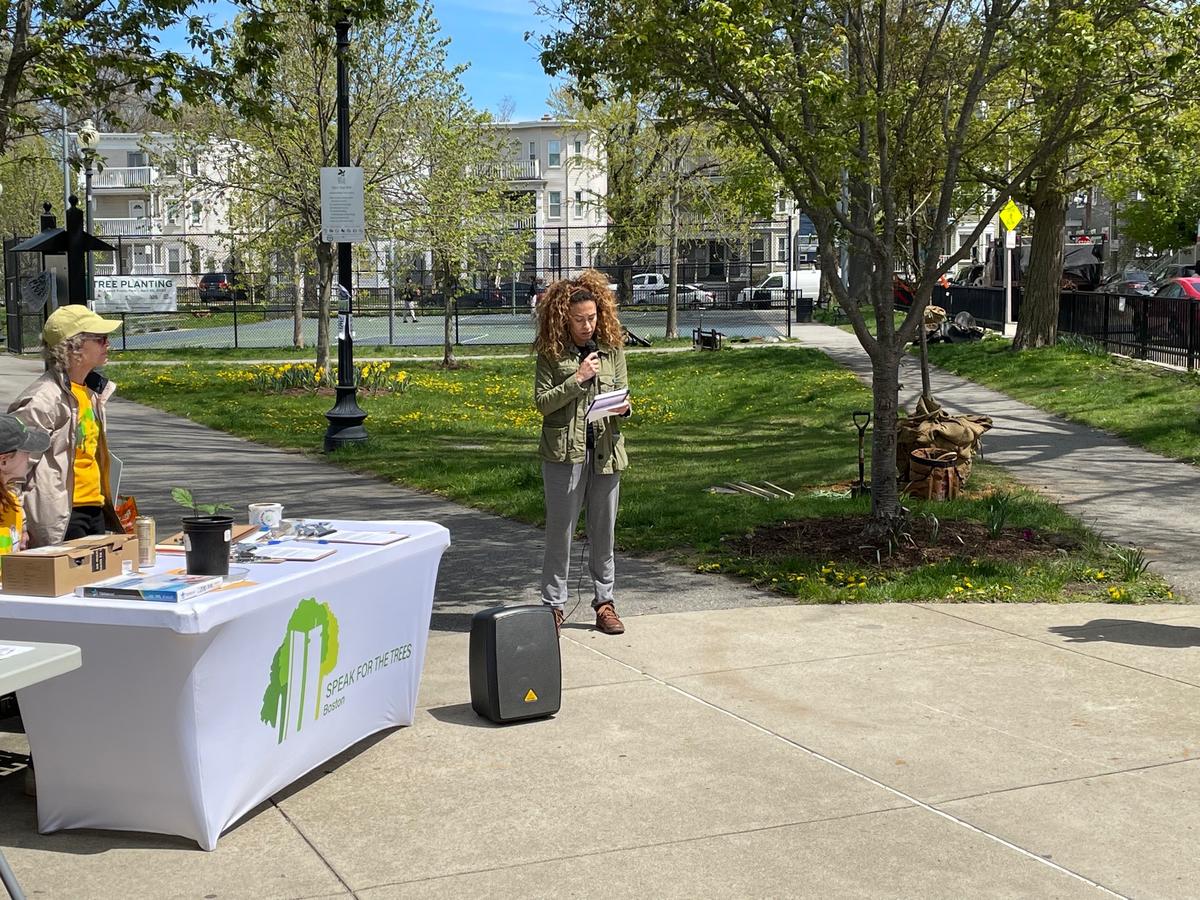 A person speaks into a microphone at Loesch Park.