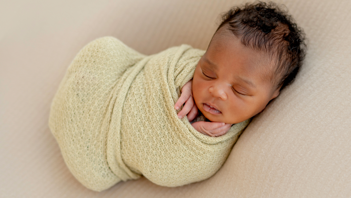 baby swaddled sleeping on back