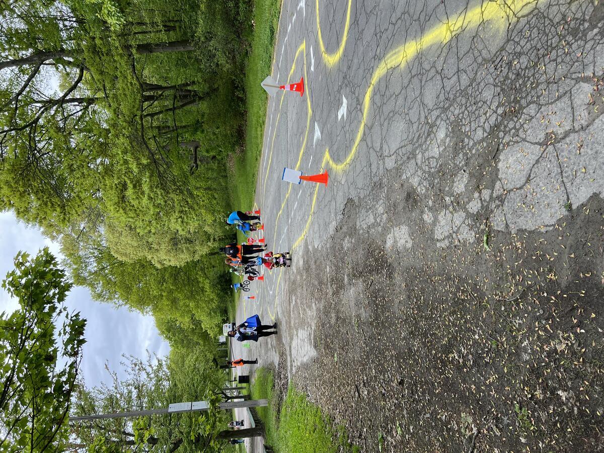 Child riding on an impermanent bike town on Playstead road at Franklin Park.