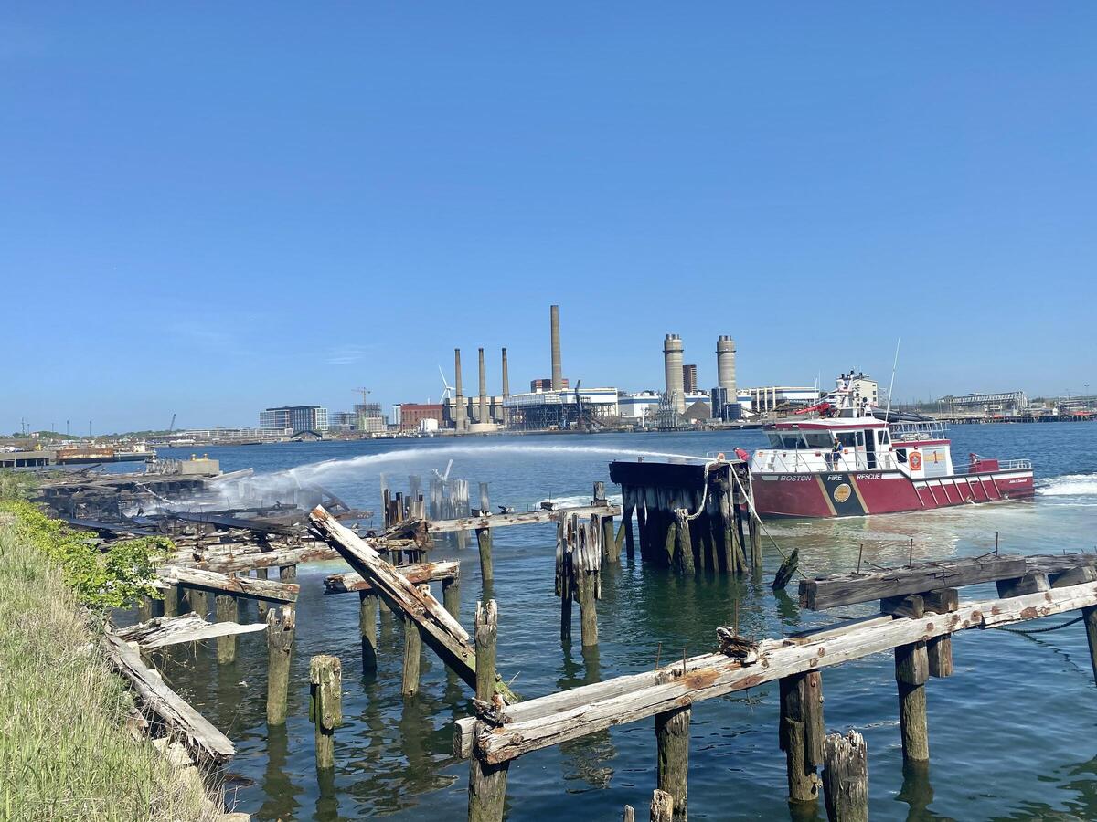 an image of a fire boat putting out a fire on the docks