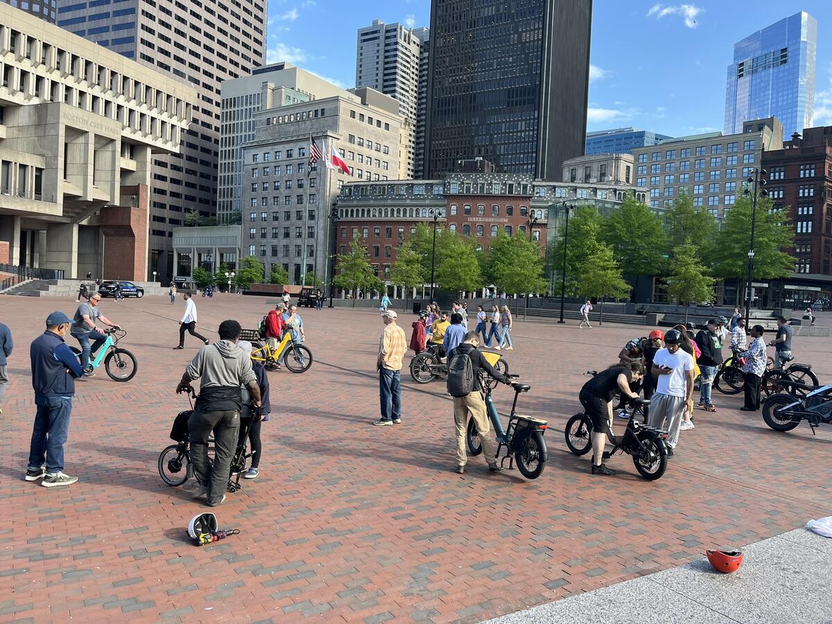 People test-riding e-bikes on the City hall plaza