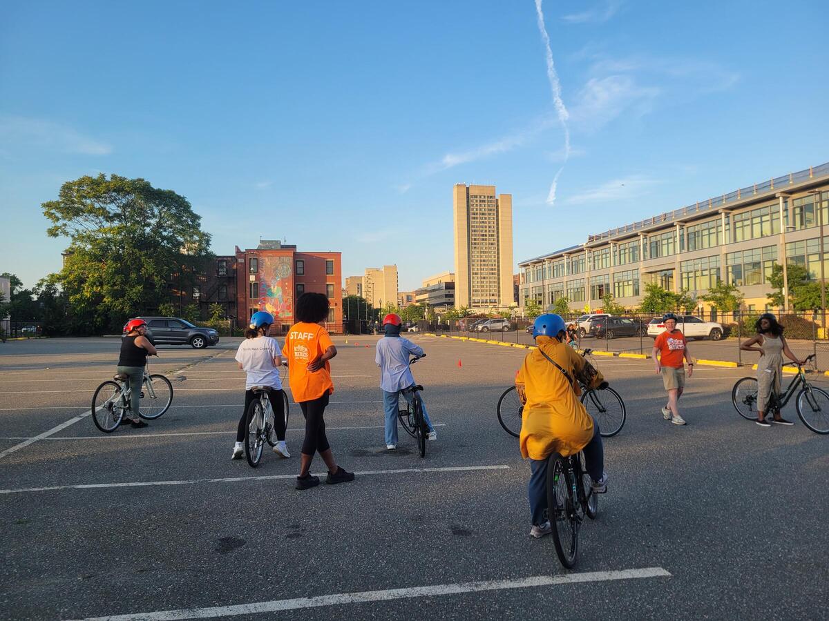 Attendees learn new bike skills during a Level 1 workshop in a parking lot