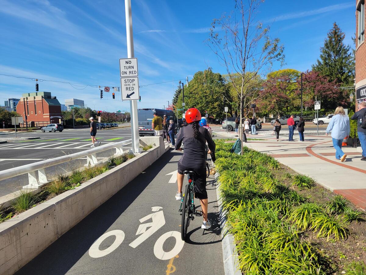 Learn to Ride workshop attendees ride in a bike lane on a sunny day