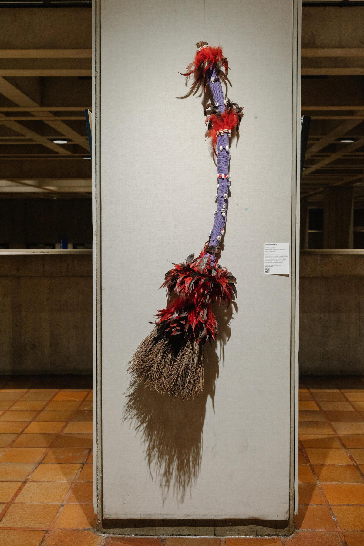 Pam Goncalves, Ritual Broom, 2023, Wood, broom straw, fabric, feathers, cowrie shells, 48 in.