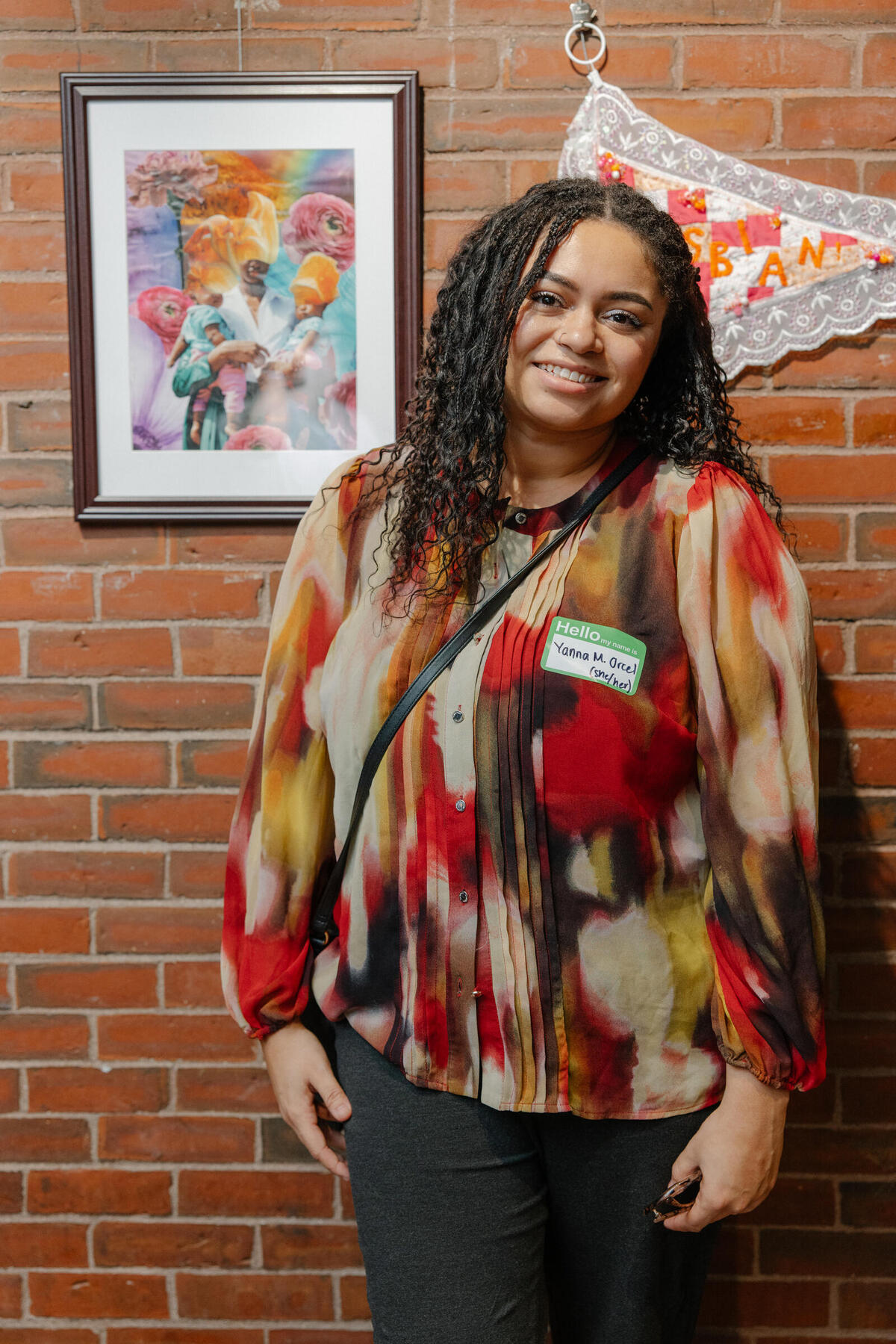 Yanna Marie Orcel standing with her winning artwork, Mother's Garden, 2023, Collage, 14 x 11 in. 