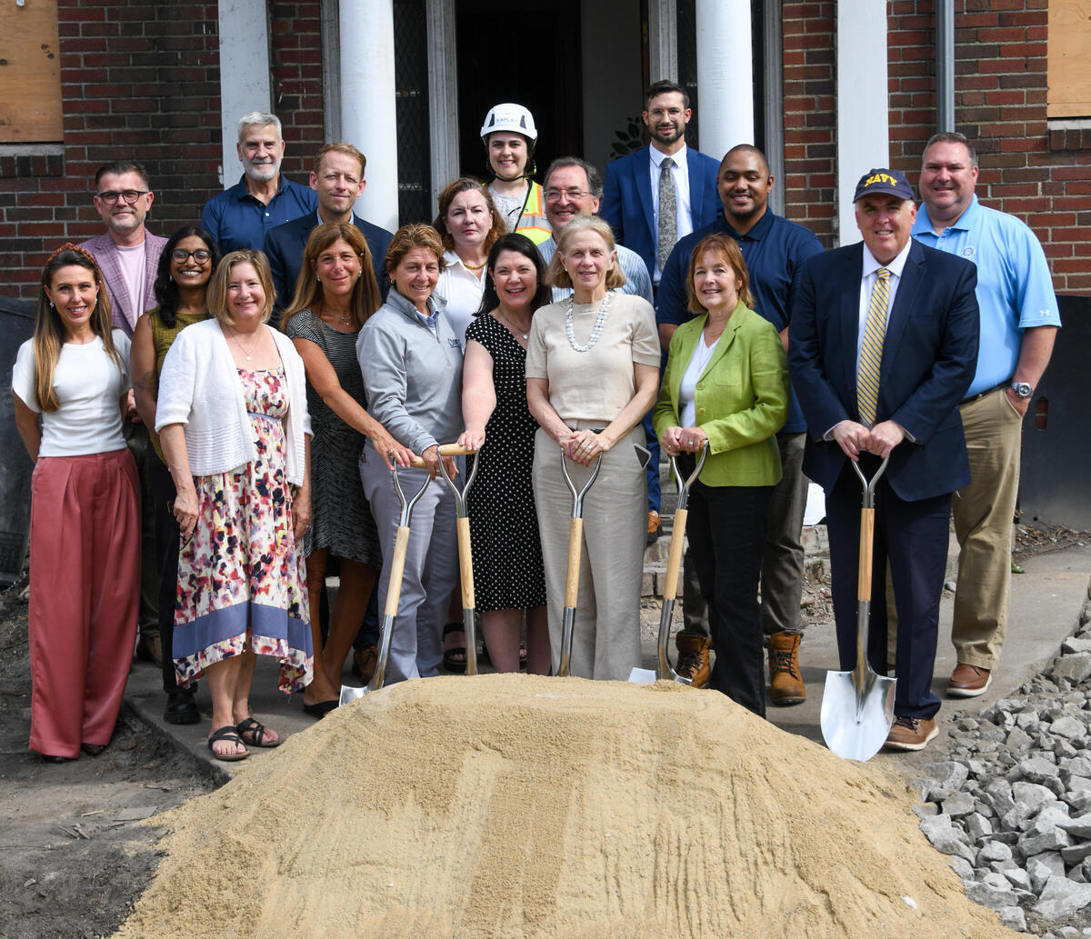 A group of people pose at the groundbreaking of McDevitt Senior Homes
