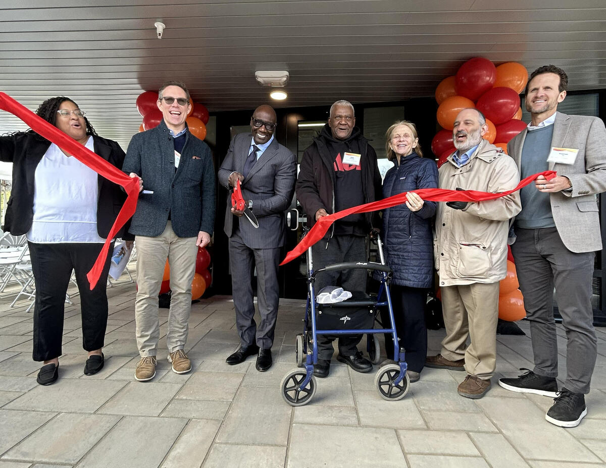 Developers, MOH staff, and new residents celebrate the ribbon cutting at 59 Bartlett Station