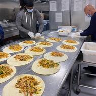Kitchen employees preparing food.