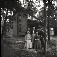 Cottage and residents, Lake Pleasant: Five women posed in front of their cottage, ca. 1900