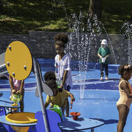 Children play on the splash pad at Mother's Rest Park