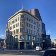 Image of the Bruce C. Bolling Building with the restored historic Ferdinand’s Blue Store facade facing the intersection of Washington and Warren streets. 