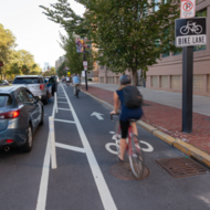 Cyclist riding in bike lane along side cars