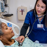 Nurse checking patient's heart beat