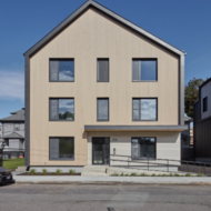 An exterior photo of 104 Norwell Street in Dorchester. A modern gray home beneath a deep blue sky.