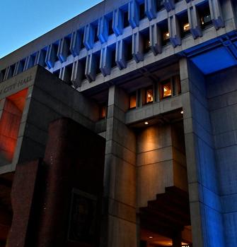 Lights are visible at night on Boston City Hall