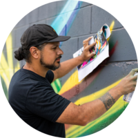 A City employee paints a mural