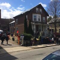 A crowd visits the archaeological dig in front of the Malcolm X-Ella Little-Collins House in Roxbury